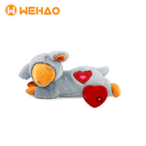 Grey and orange heartbeat soothing lamb plush toy with a red electronic heartbeat simulator for puppy anxiety relief and behavioral training, featuring Wehao logo.