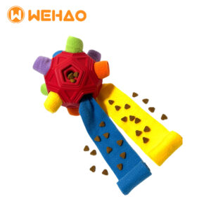 Red TPR interactive dog snuffle ball with multi-colored pull-out fabric rolls for hiding kibble and treats, featuring the Wehao logo, ideal for wholesale and OEM orders.