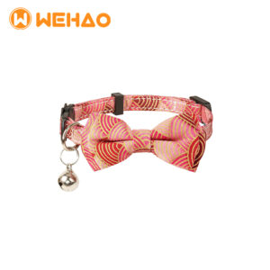 Elegant pink and gold geometric patterned cat collar featuring a removable bow tie, breakaway safety buckle, and silver bell, branded with Wehao logo for B2B wholesale.